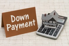 Home Mortgage Down Payment, A Gray House, Brown Card And Calculator On Stone Background